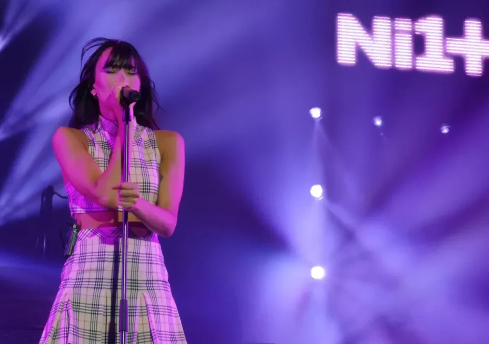Aitana canta al micrófono durante un concierto