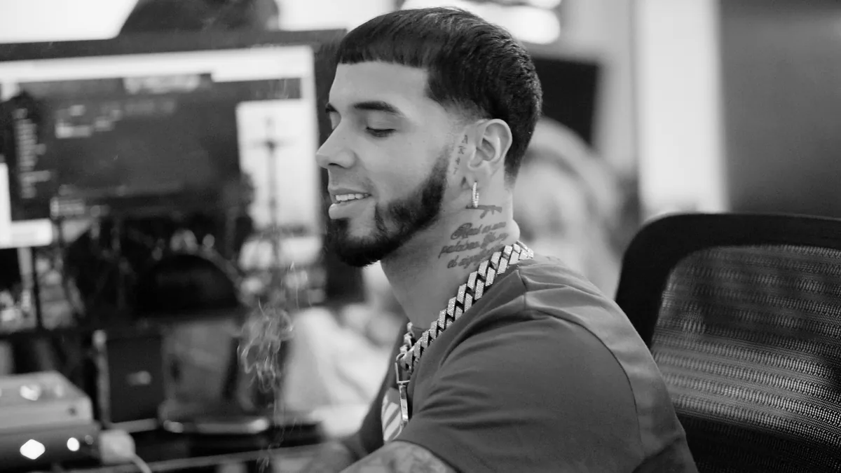 Retrato en blanco y negro de Anuel AA de perfil en un estudio